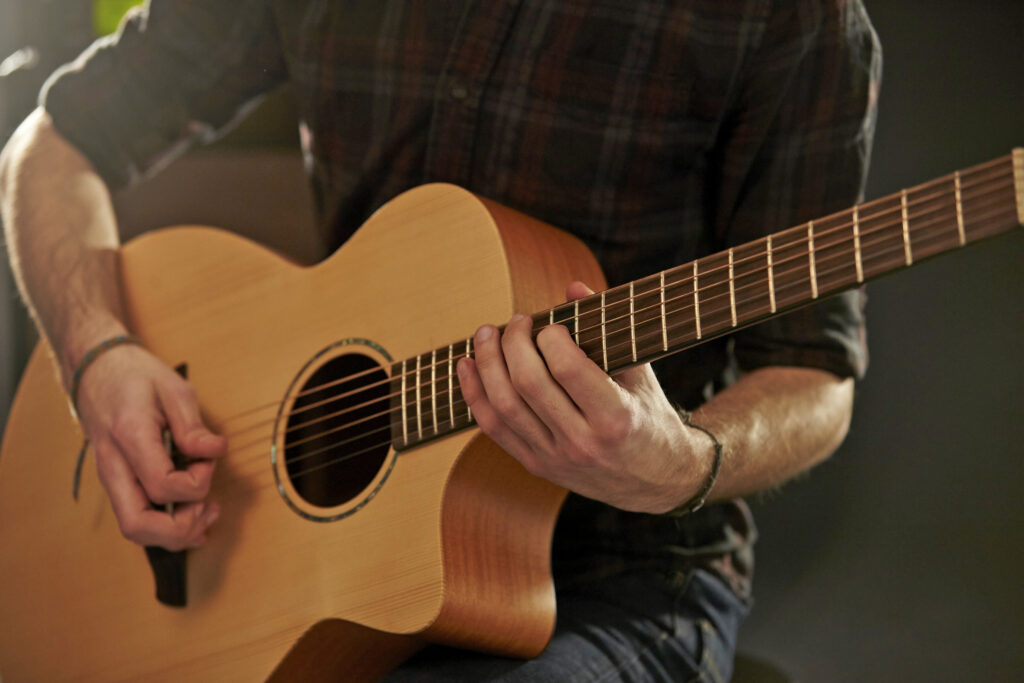 man playing acoustical guitar