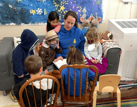 PreSchool family teacher reading to children